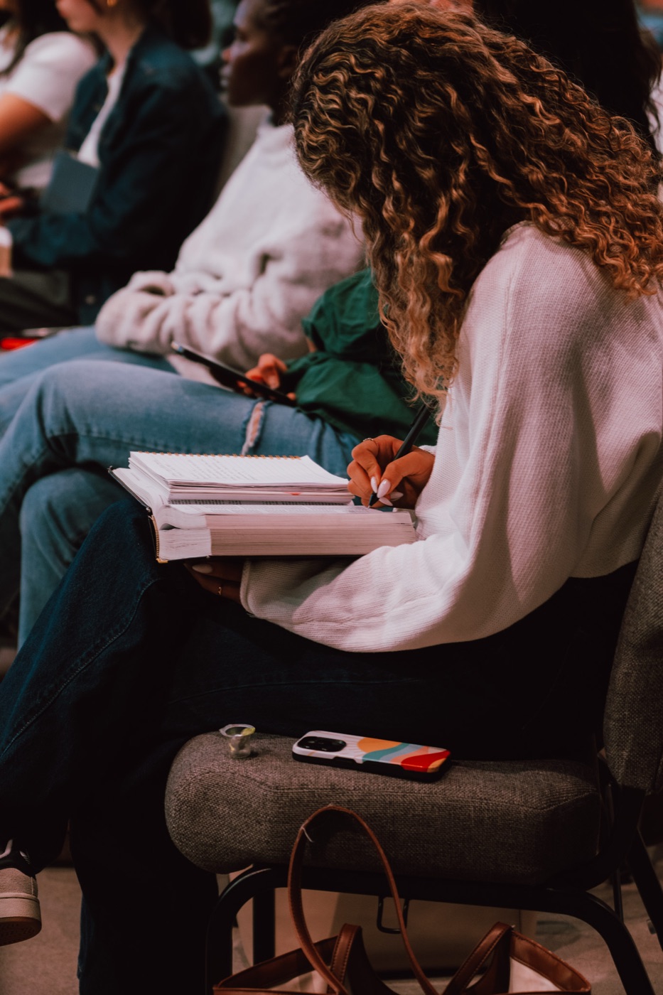 A student taking notes during a teaching